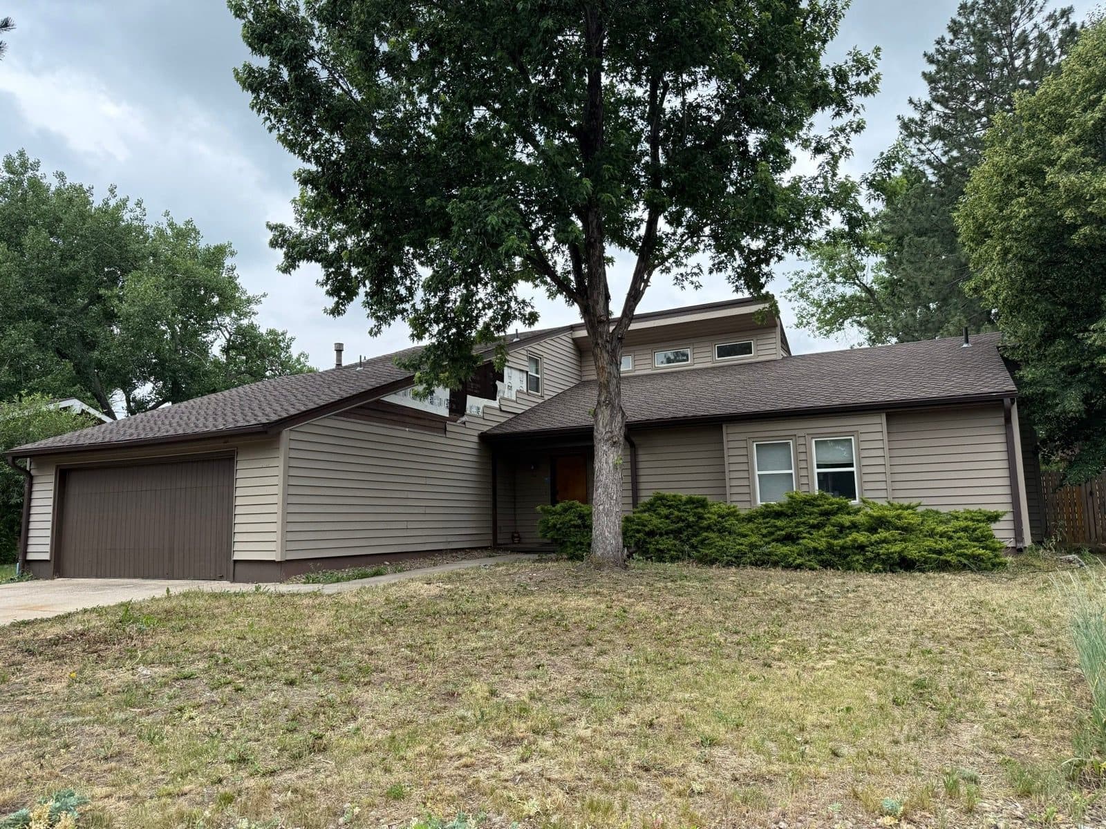Boulder Colorado home before wind-damaged vinyl siding replacement