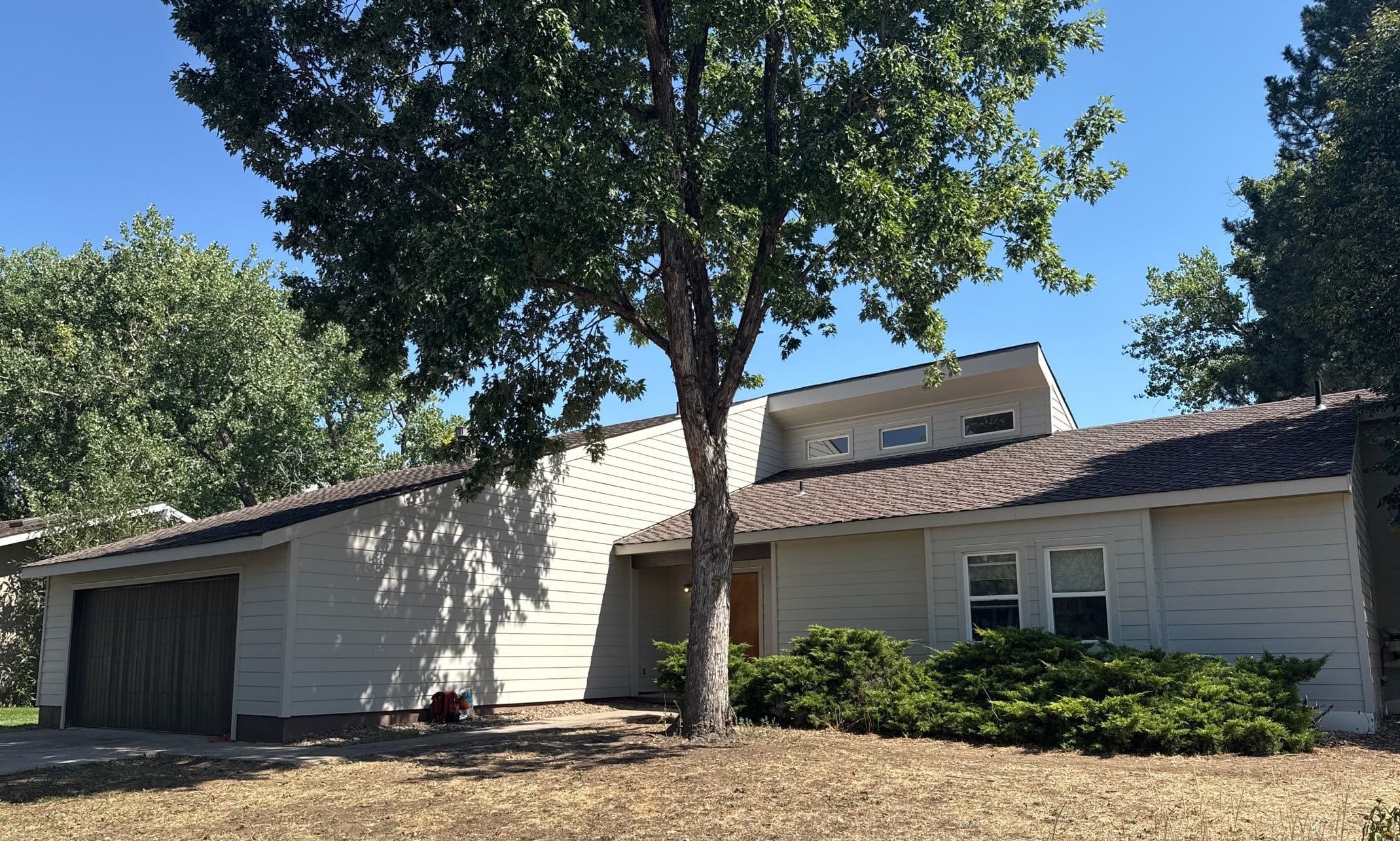 Wind-damaged vinyl replaced with James Hardie siding and trim on Boulder Colorado home
