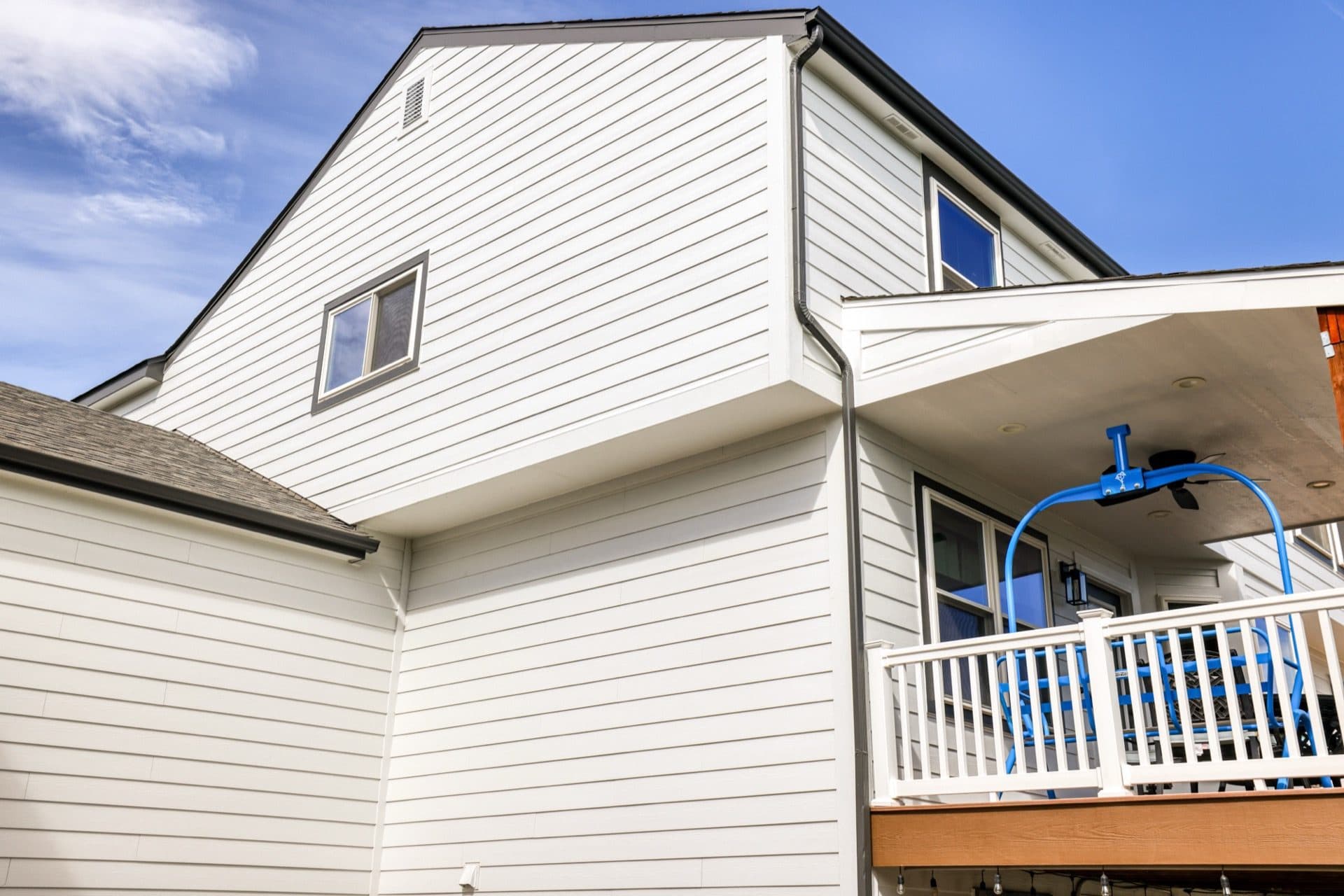 White lap siding installation on two-story home in Highlands Ranch Colorado
