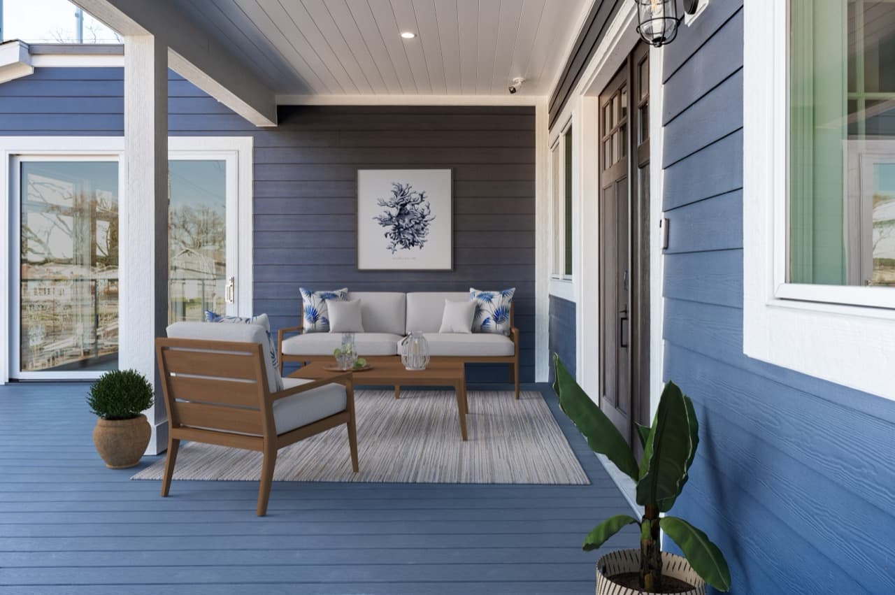 Blue James Hardie lap siding on home exterior with covered porch and outdoor seating