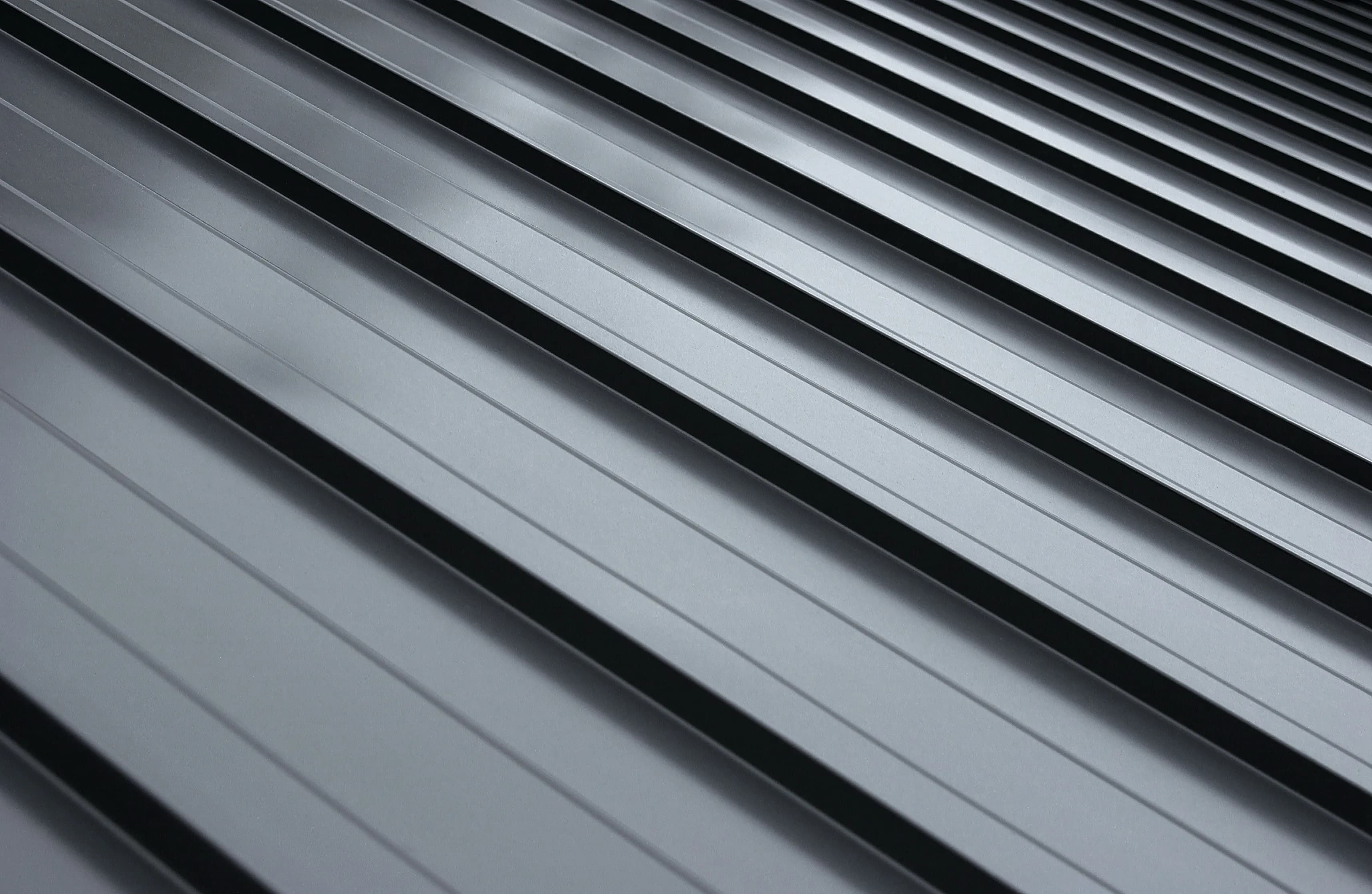 Standing seam metal roofing panels with raised seams