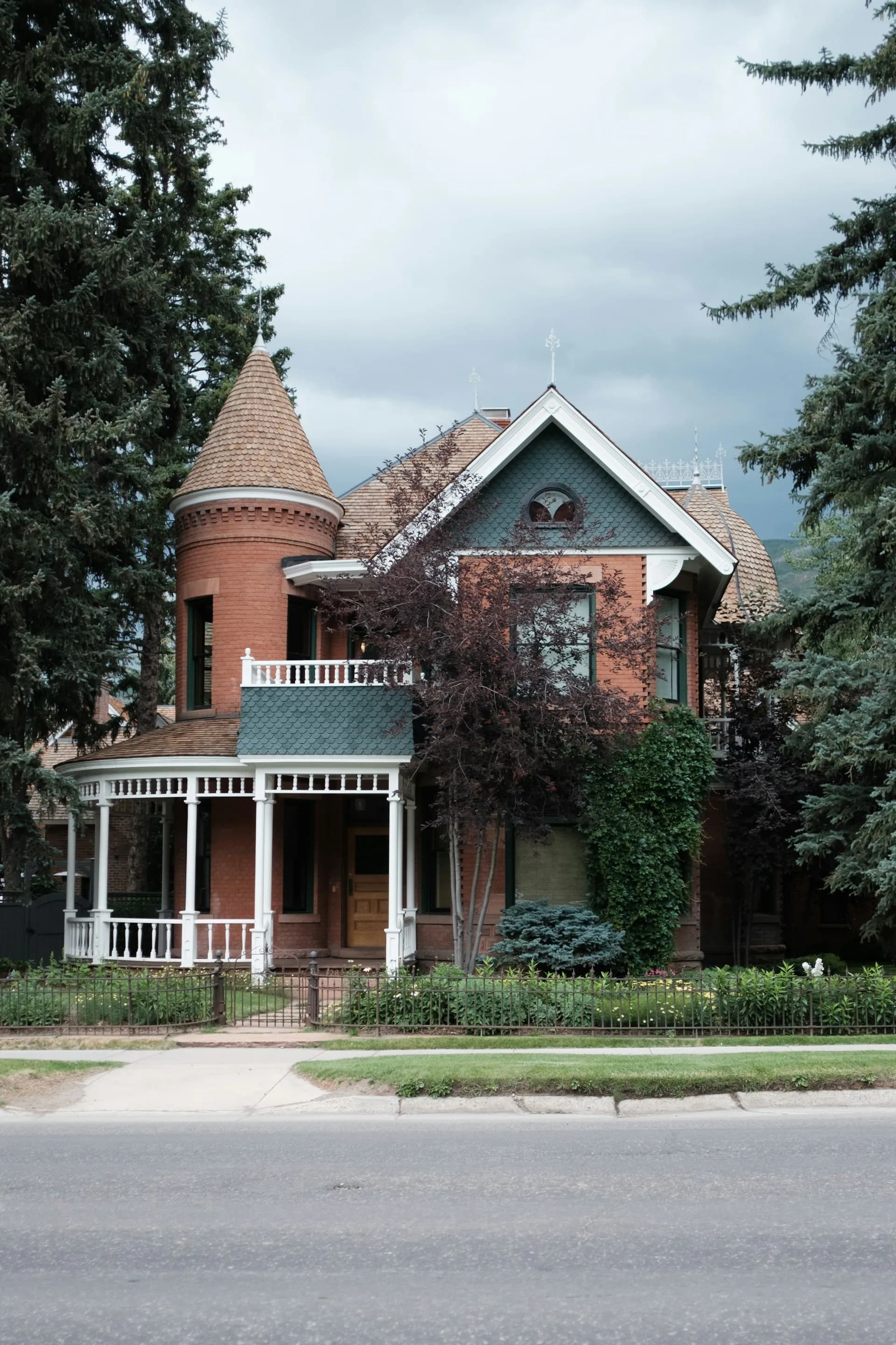 Victorian-style brick home with detailed roofing in the Centennial Colorado area