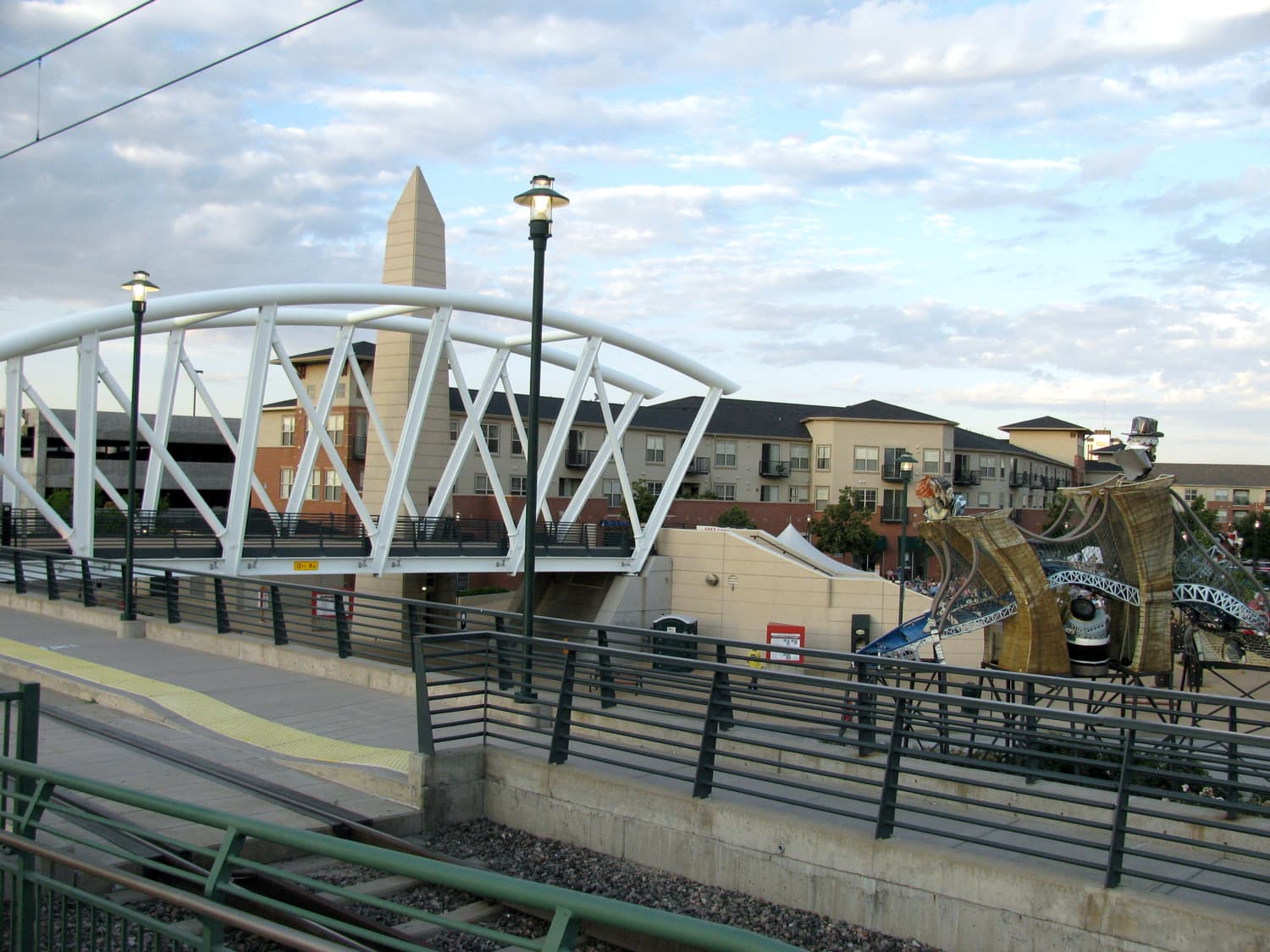 Englewood Colorado city center with light rail bridge and residential buildings