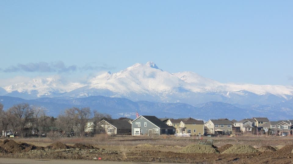 Longmont Colorado residential neighborhood with Longs Peak and snow-capped Rocky Mountains in background