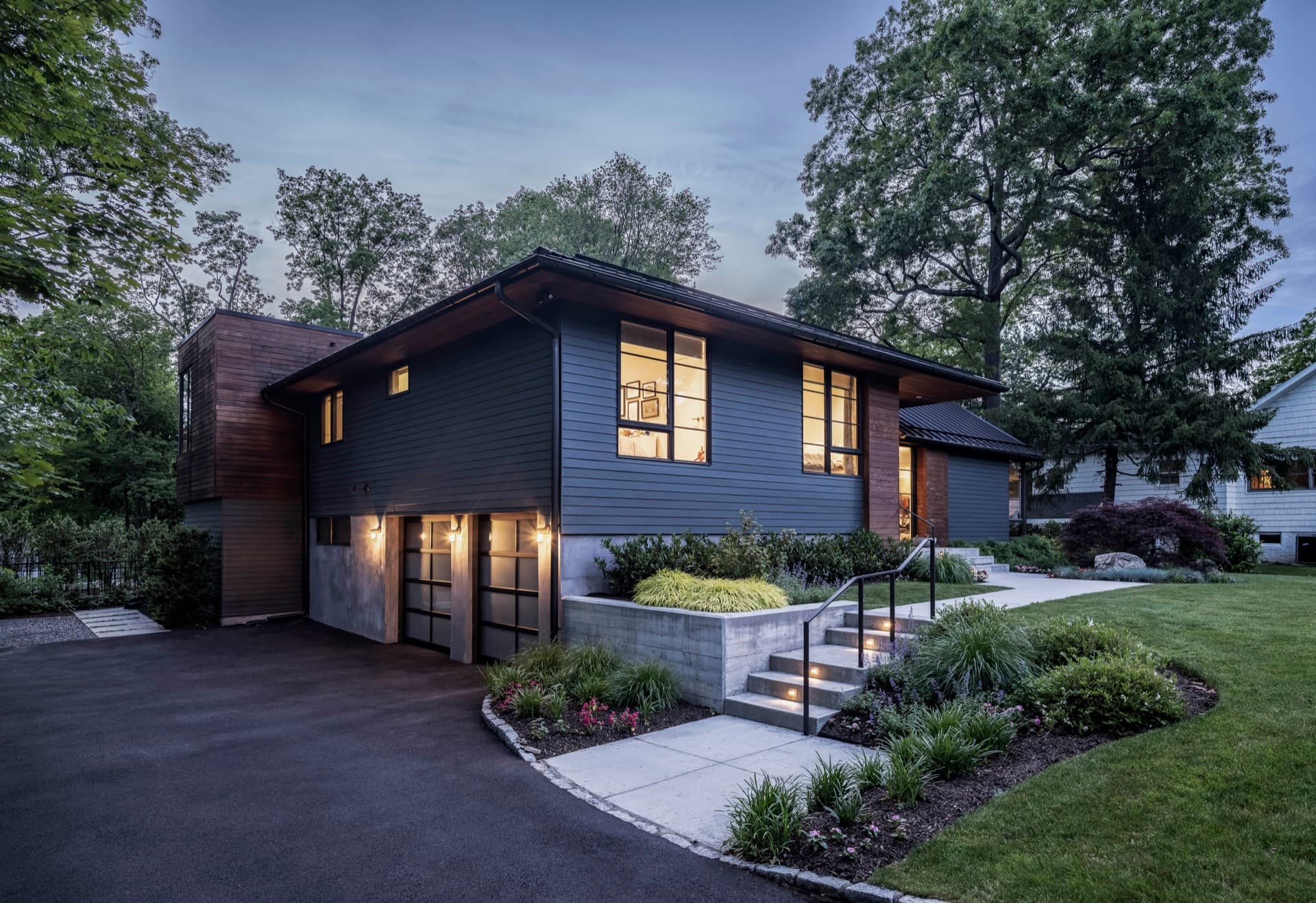 Modern home with dark James Hardie siding and wood accents at dusk in Colorado