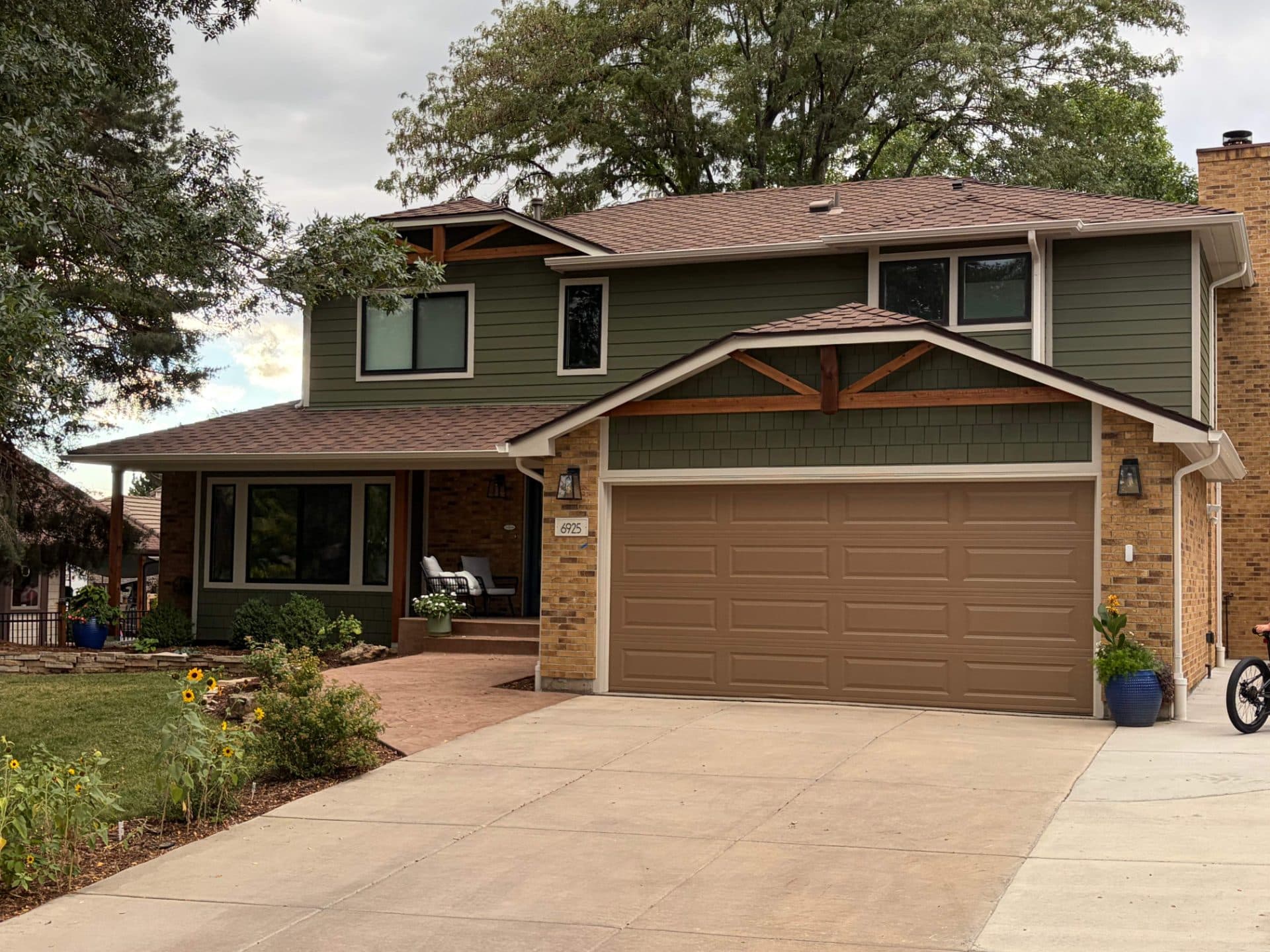 After photo of a home in Arvada, CO showing new James Hardie siding in Cobblestone and Mountain Sage with new gable brackets.