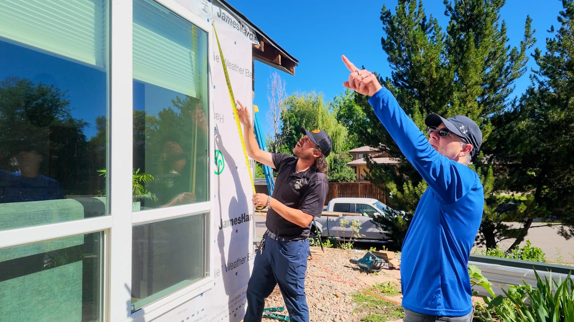 The Roofing & Siding Company project manager working with homeowner to plan batten spacing in Boulder, CO.
