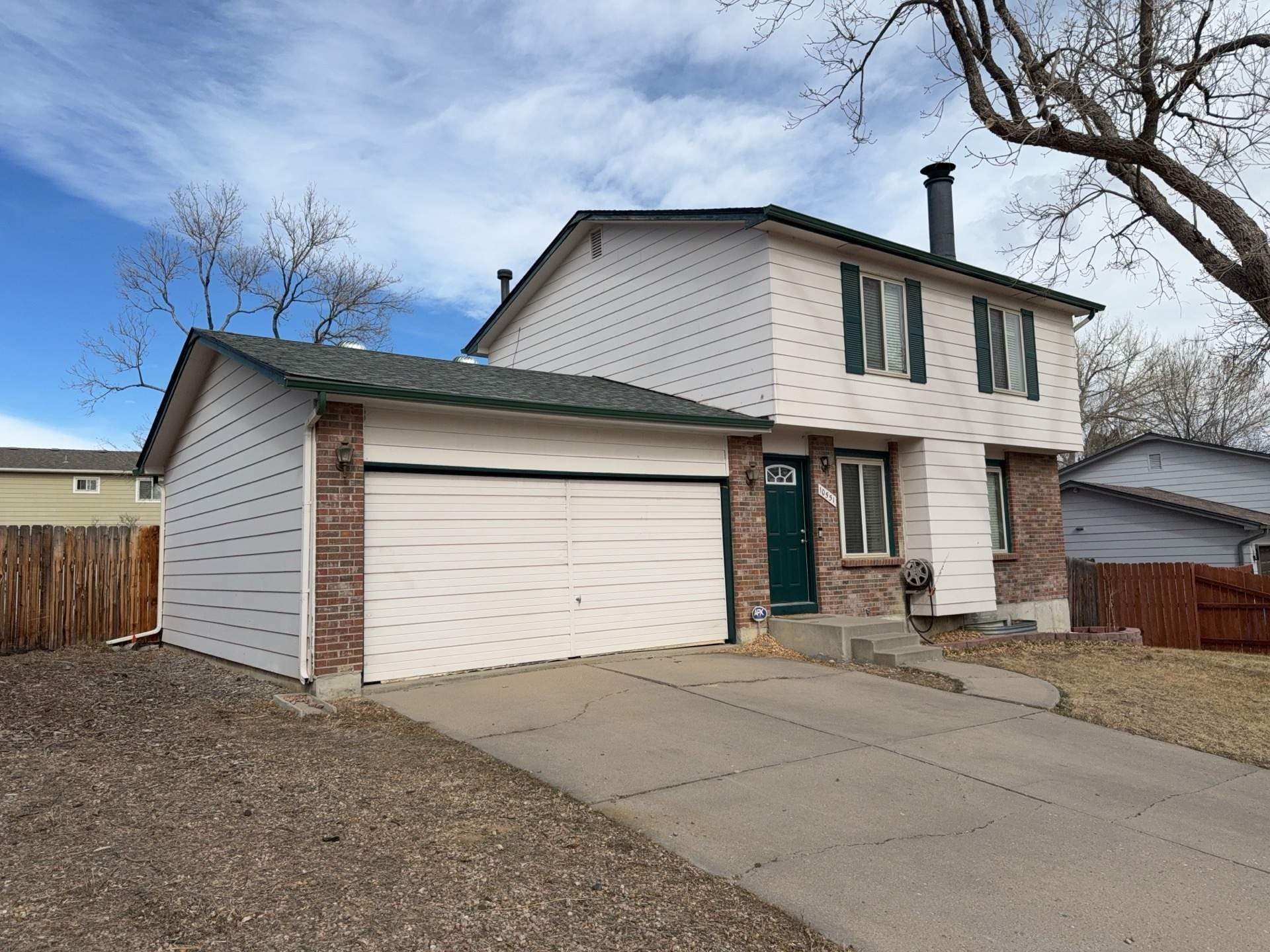 Old white siding on a home in Westminster, Colorado, before new James Hardie siding installed.