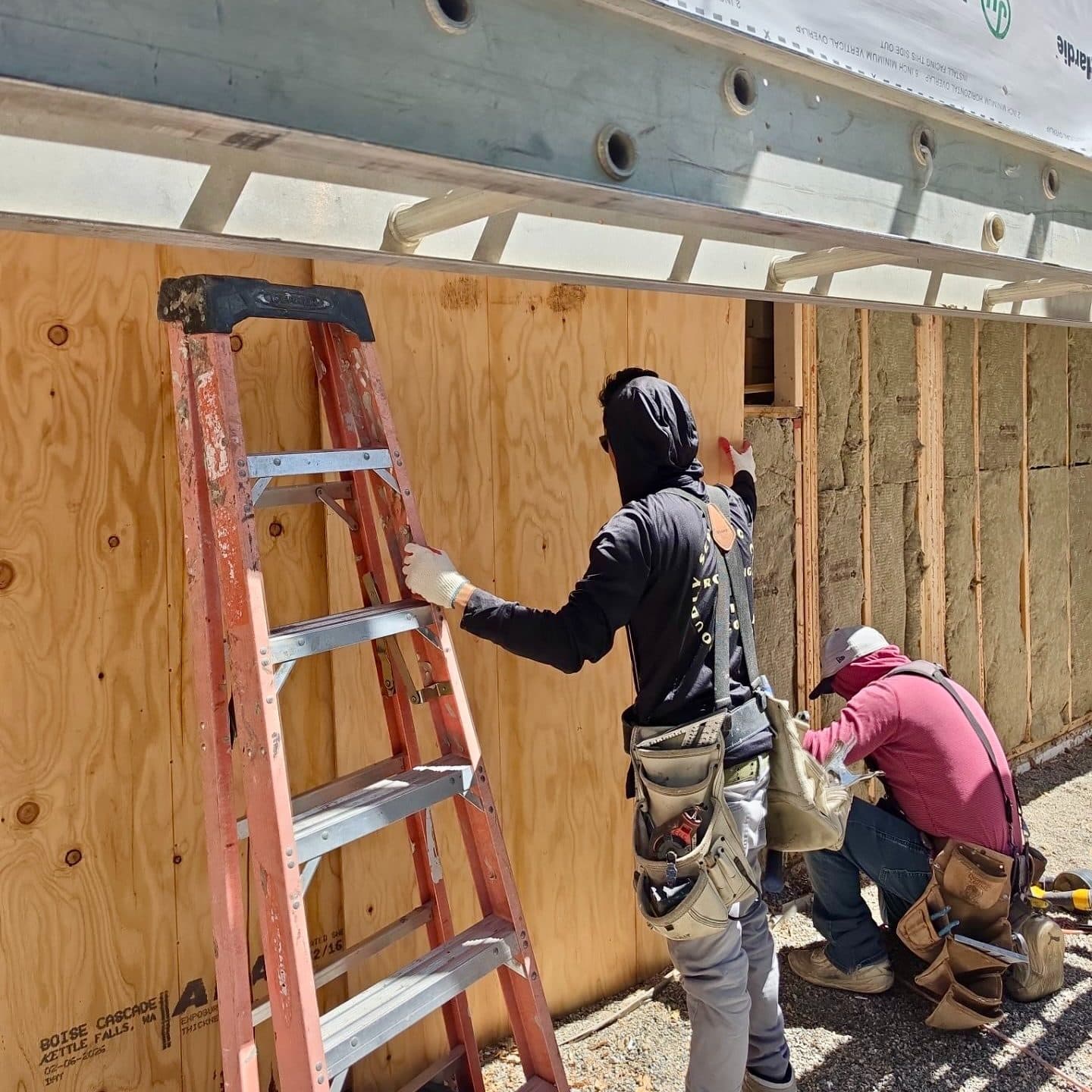 The Roofing & Siding Company crew installing new sheathing for a siding replacement project in Boulder, CO.