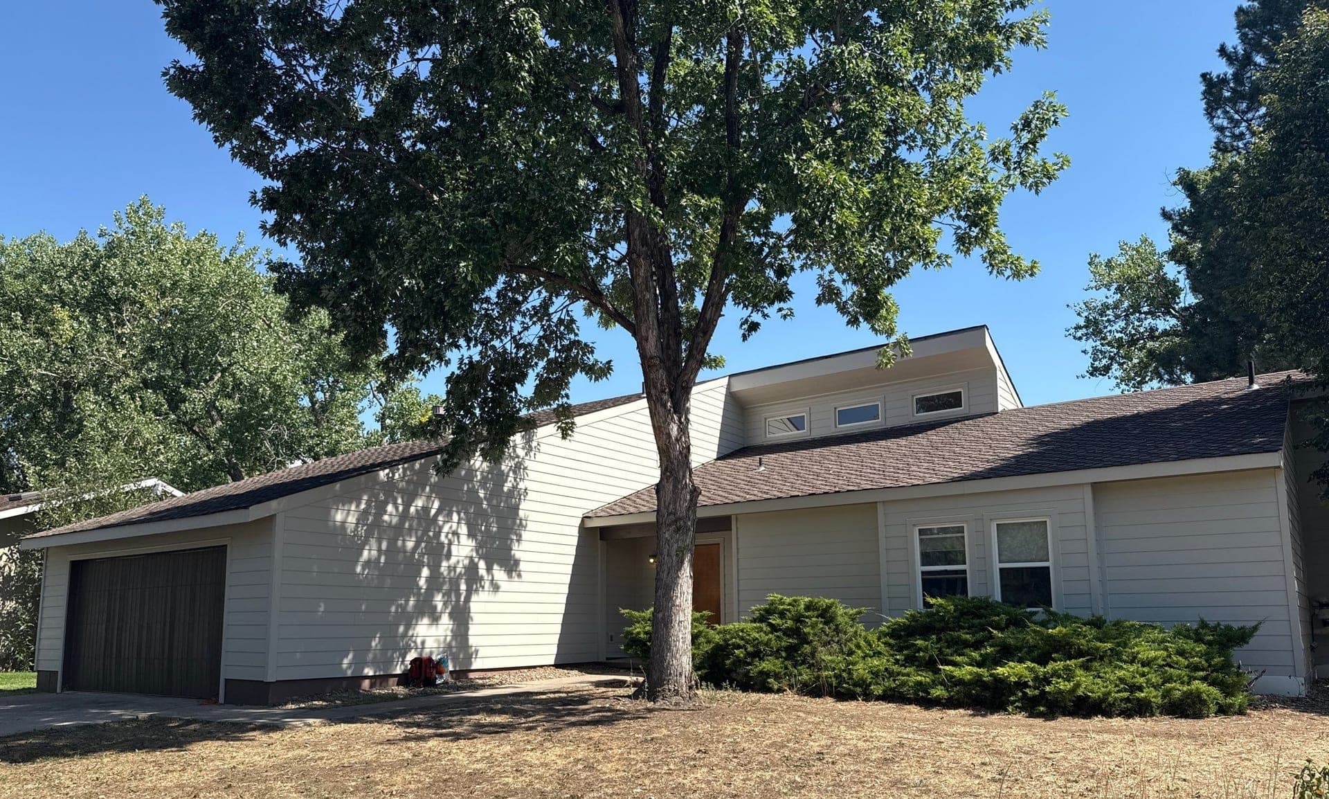 Wind-damaged vinyl replaced with James Hardie siding and trim on Boulder Colorado home
