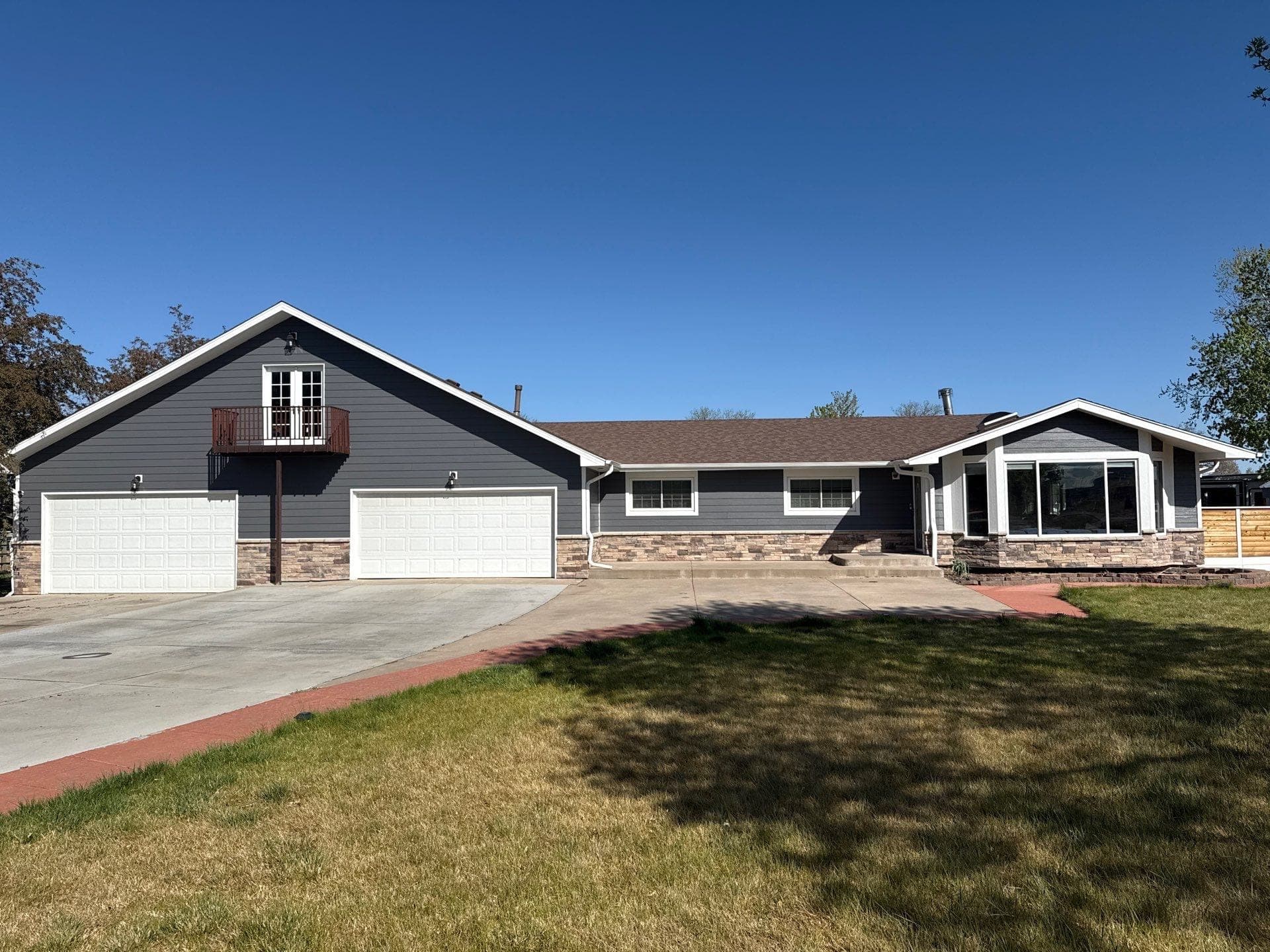 LP SmartSide siding with Versetta Stone accents and new soffits and fascia on Brighton Colorado home