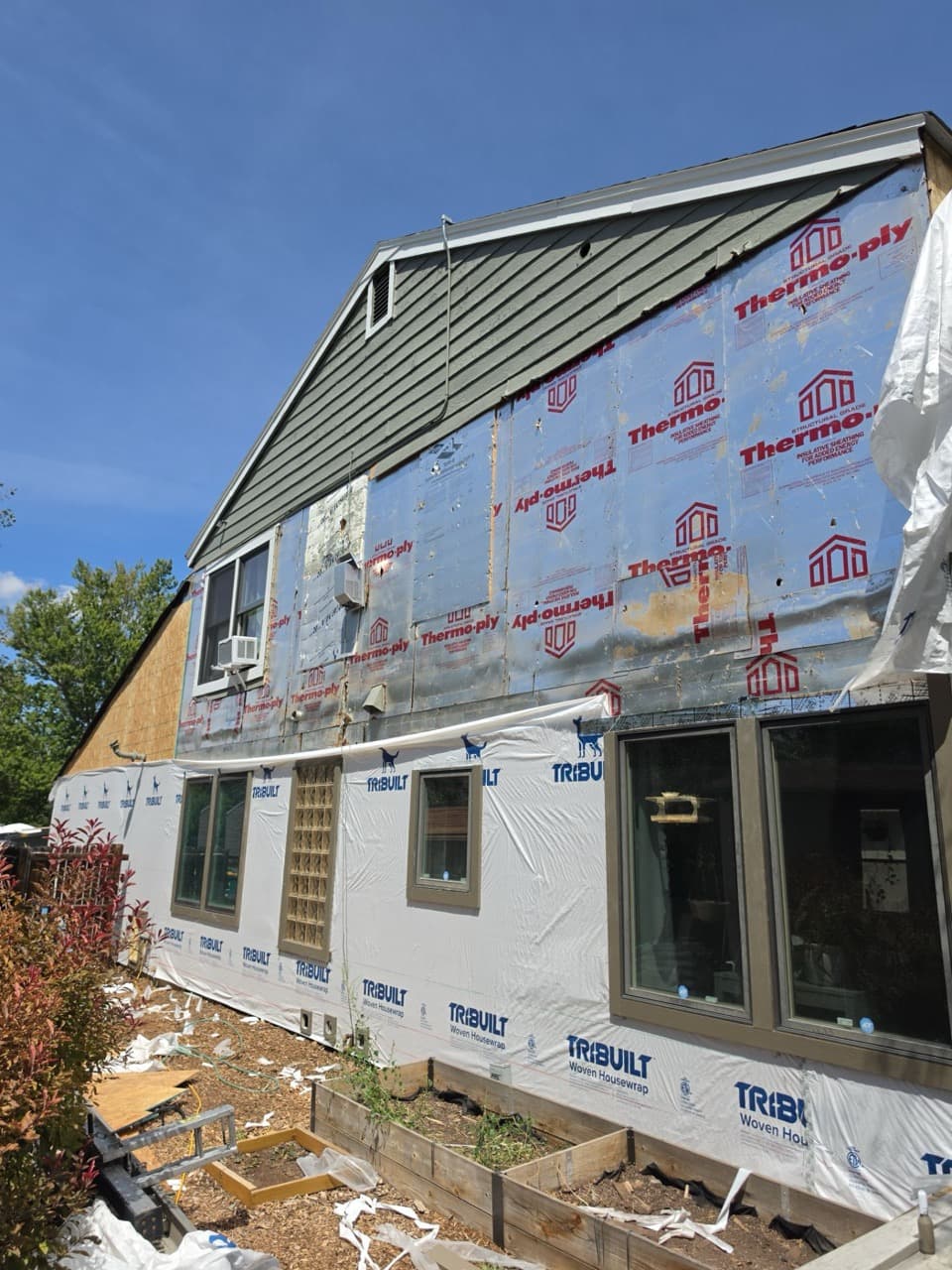 New James Hardie siding installation in progress on Aurora, CO home showing Thermo-ply sheathing.