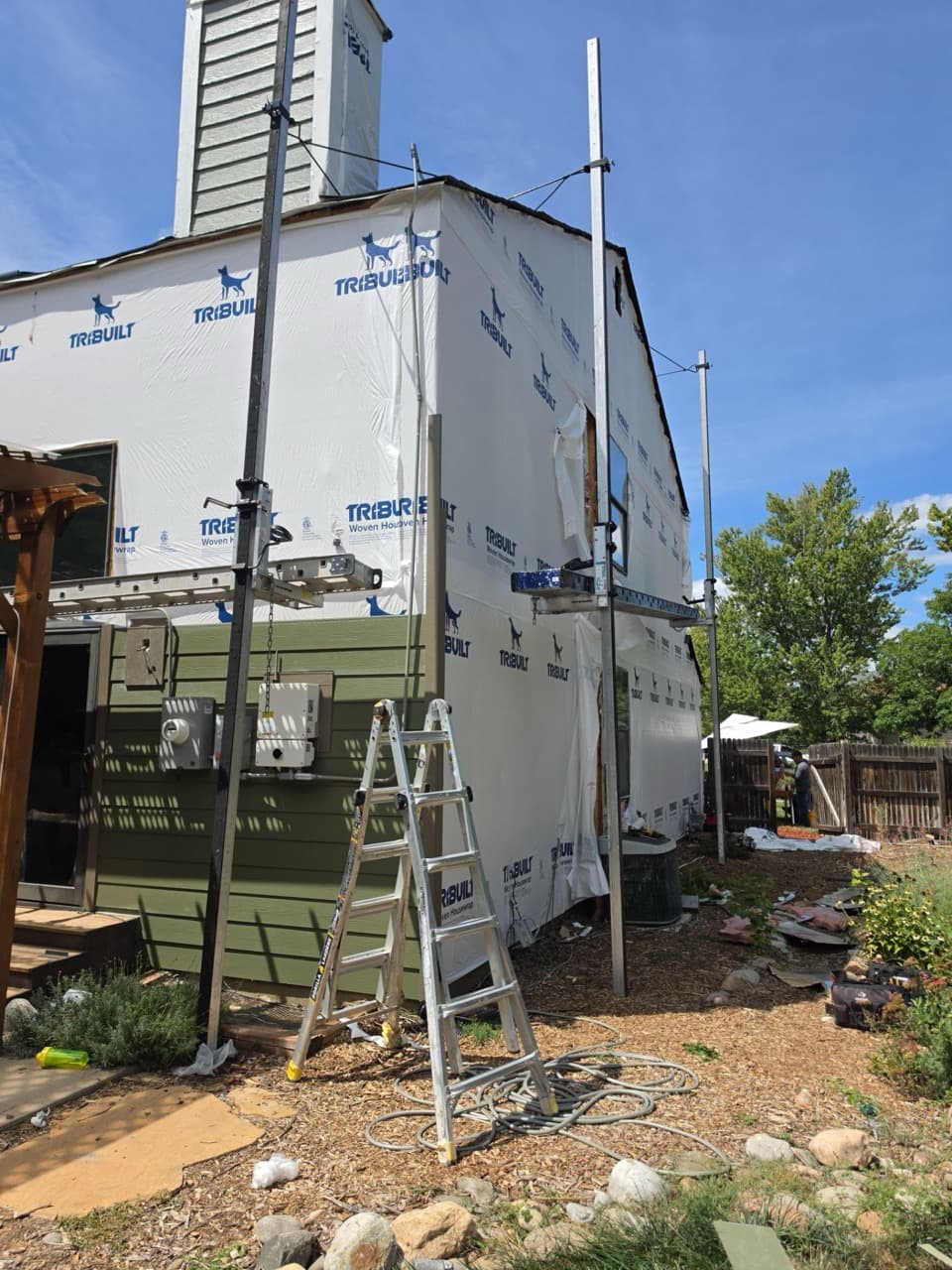 Installing James Hardie lap siding on Aurora, CO home with TribuiltWRB weather barrier.