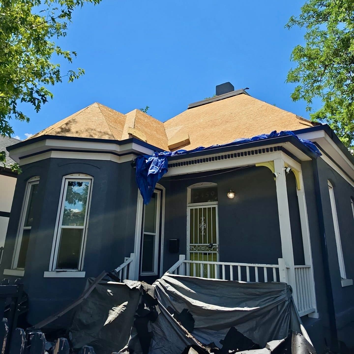 Roof replacement in progress in Denver, CO. Roof sheathing is visible.