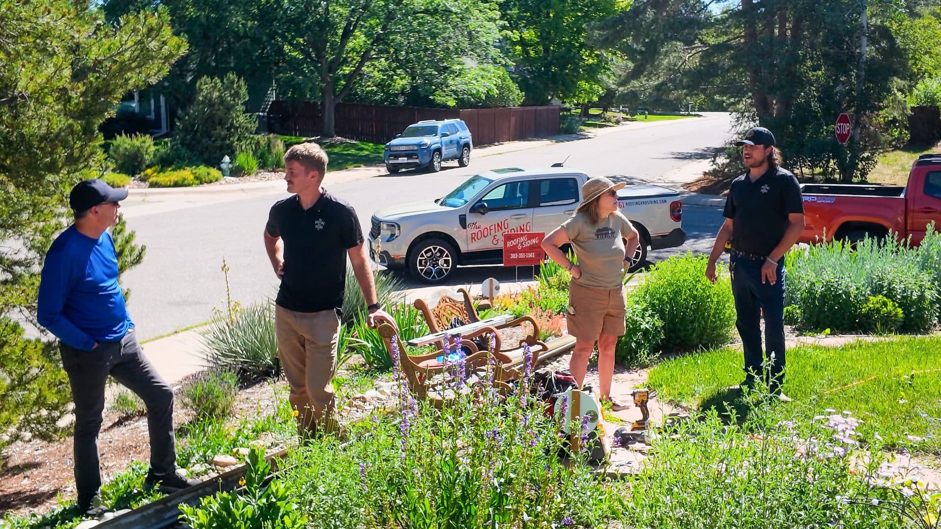 The Roofing & Siding Company talking to customers outside their home in Boulder, CO.
