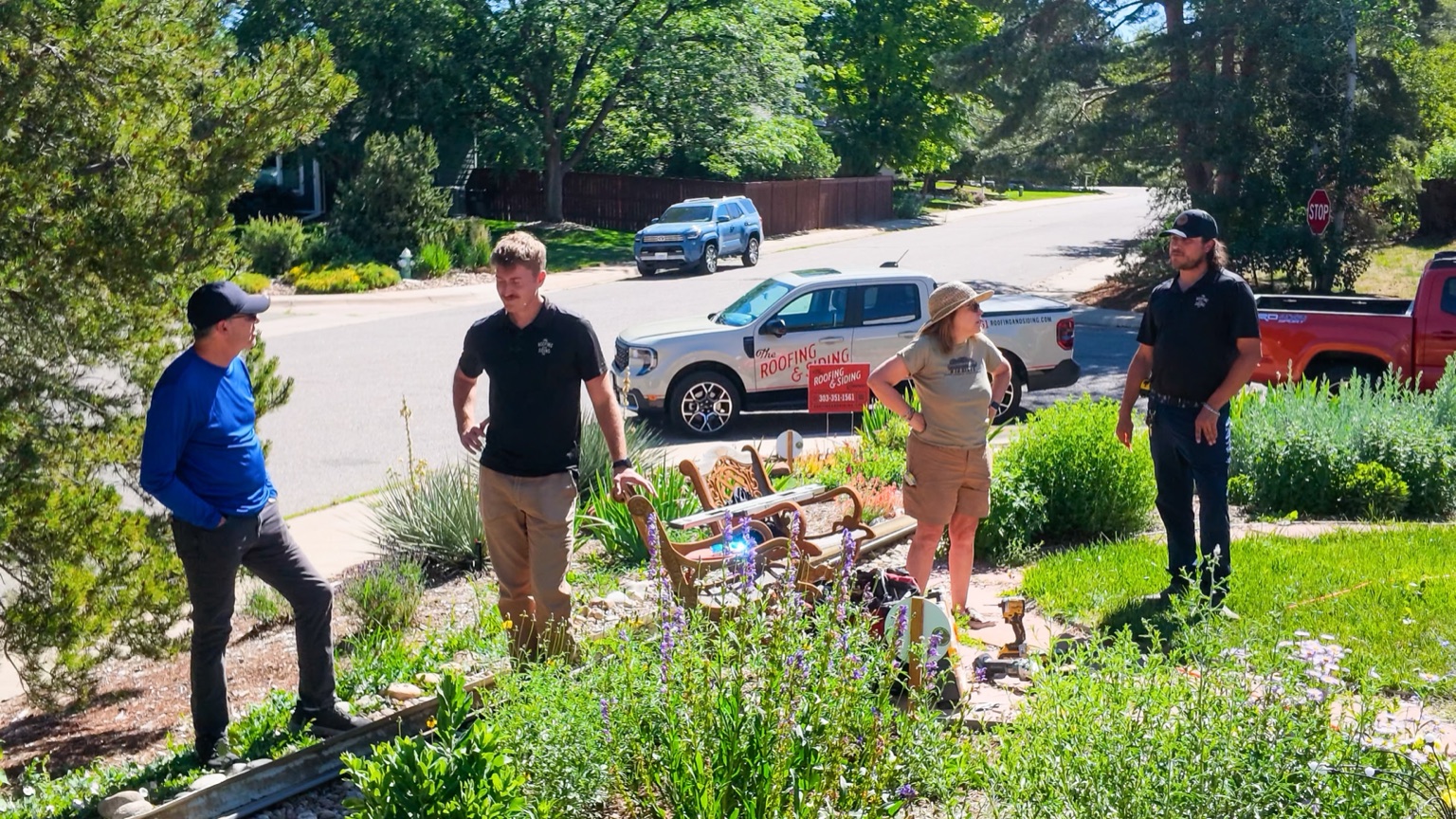 Bobby with The Roofing & Siding Company team in the front yard, with company truck visible in the background, Boulder, CO